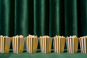 Popcorn Boxes Aligned in Front of Green Curtain