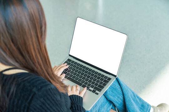 Close-up of laptop screen with blank white display in workspace