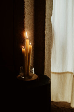 Soft Candlelight Illuminates a Cozy Corner Near a Window