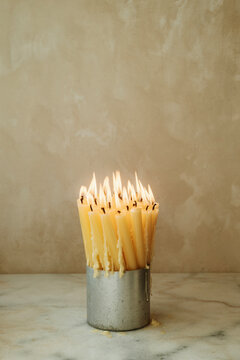 Burning Candles in a Simple Holder Creating Warm Light