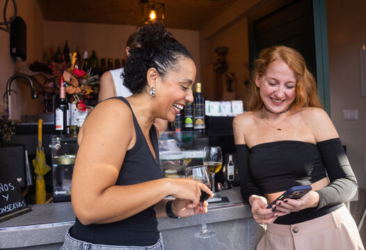 Friends Enjoying Drinks and Laughter at a Cozy Bar