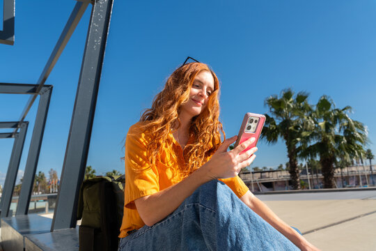 Happy woman with phone blue skye