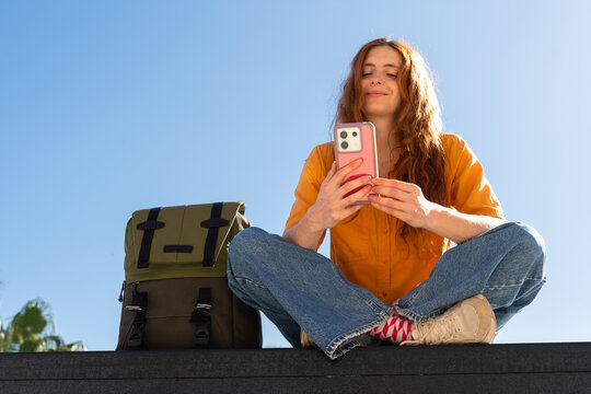 Happy woman with phone blue skye