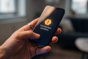 Hand holding smartphone displaying connection problem warning on screen in blurred room