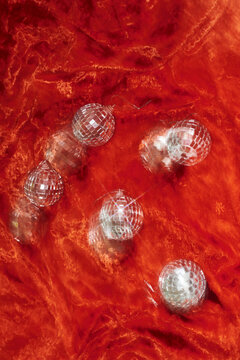 Christmas baubles on red velvet with motion blur