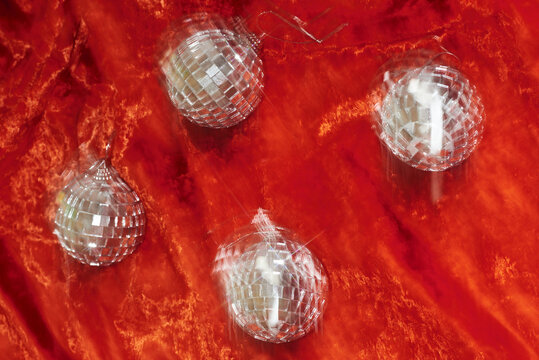 Christmas baubles on red velvet with motion blur