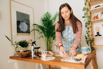 Woman preparing pottery tools at the working table
