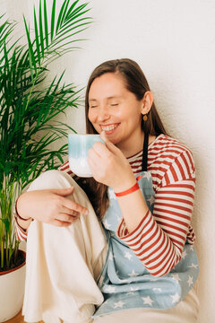 Laughing woman enjoying tea break