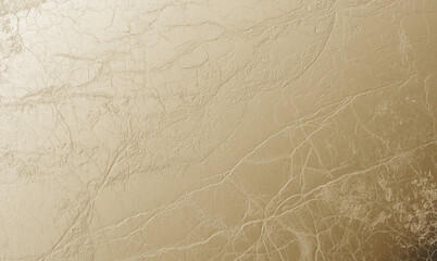 A luxurious foil texture featuring a crumpled metallic surface with fine cracks and details, creating a rich abstract background.
