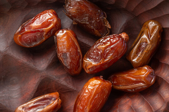 Dry Dates Displayed on a Wooden Surface