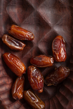 Delicious Dates Arranged on a Wooden Plate 