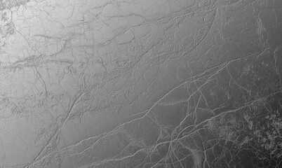 A luxurious foil texture featuring a crumpled metallic surface with fine cracks and details, creating a rich abstract background.