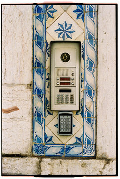 Doorbell framed by Portuguese blue azulejo tiles