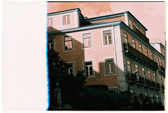 Pink sky over building in Lisbon, first frame on roll