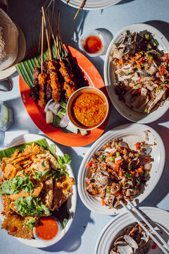 Assorted Malaysian street food dishes on table