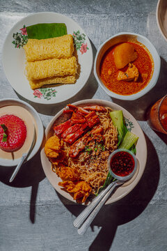 Malaysian street food with Wantan Mee and Roti Jala with chicken curry