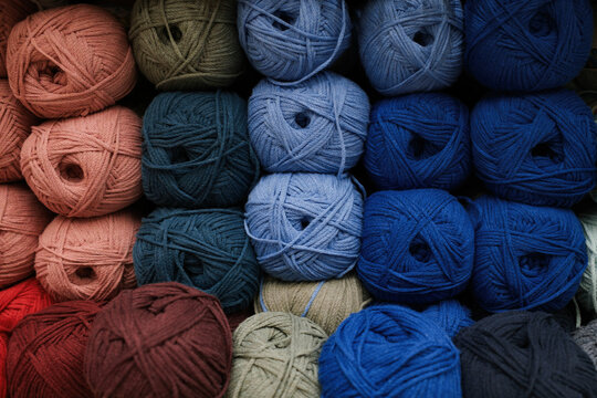Colorful yarn balls arranged neatly on display in a store