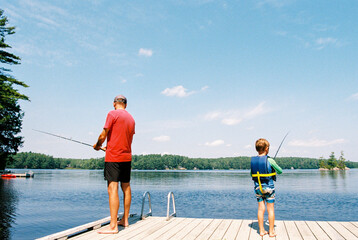 Father and son fishing together on the lake