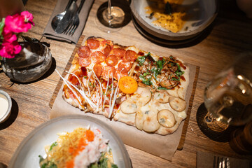 Gourmet flatbread pizza with assorted toppings  

