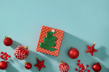 Christmas gift with festive ornaments arranged on a vibrant blue