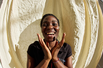 Smiling woman expressing joy against a neutral background
