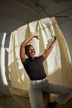 Joyful celebration in studio with cheerful person striking a pos