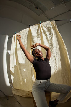 Joyful dancer celebrating in a studio with light background