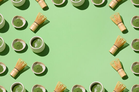 A beautifully arranged matcha tea set featuring bowls, whisks