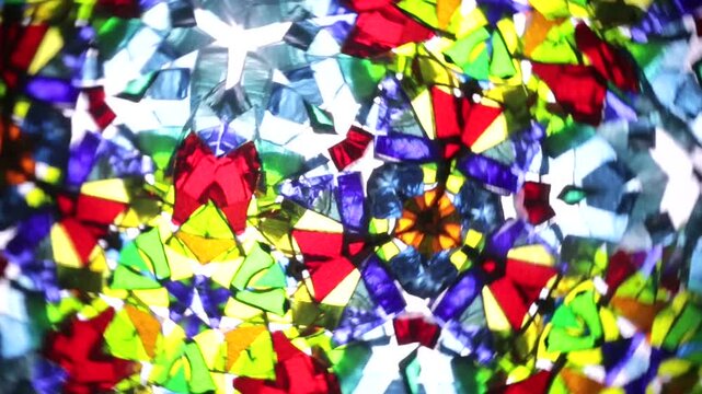 Mesmerizing rotation of a natural kaleidoscope. Vibrant shards of glass create intricate, ever-changing symmetrical patterns and colorful abstract mosaics in a fluid, hypnotic motion.