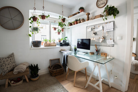 Scandinavian style home office with houseplants and desk