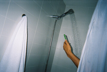 a man uses his phone in the shower, 35mm film