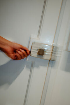 a man unlocking a white door, captured through shutter drag