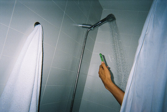 a man uses his phone in the shower, 35mm film
