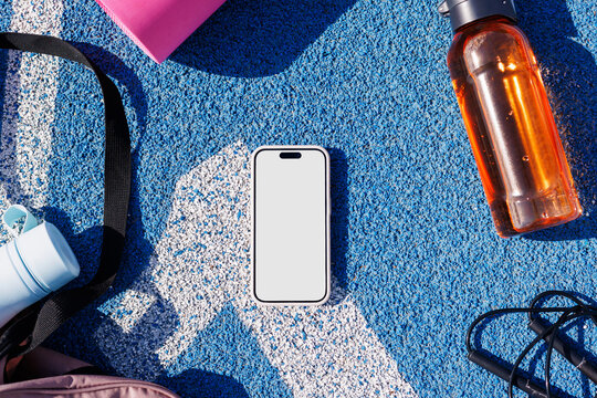 Mockup Phone with White Screen on Blue Sports Surface with Gear