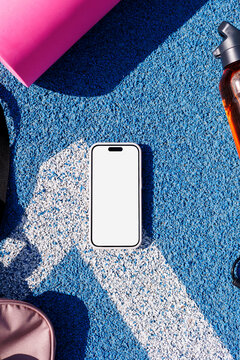 Smartphone Mockup with White Screen on on Blue Sport Track 
