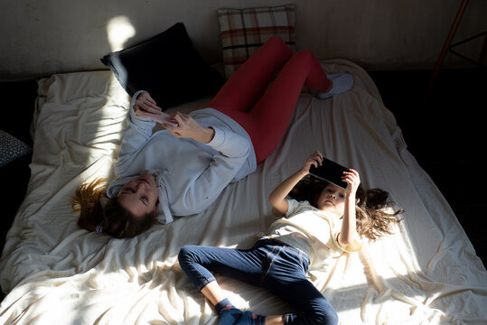 Mother and child spend time together using phones