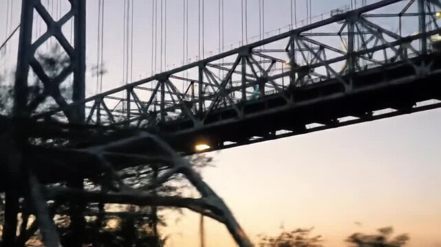 Suspension bridge silhouette against twilight sky daytime exterior view