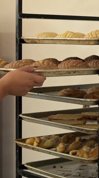 arranging sweet bread in the bakery