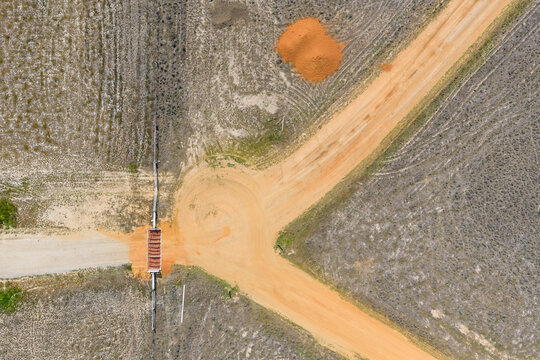 Forked road behind a cattlegrate in a farm gateway