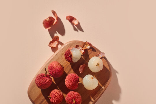Lychees on a wooden board, showcasing the fresh, sweet fruit