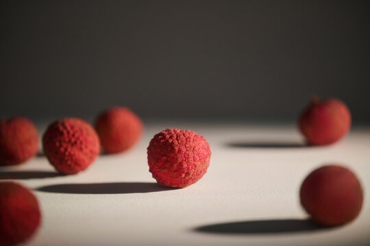 A close-up shot of several fresh and ripe lychee fruits