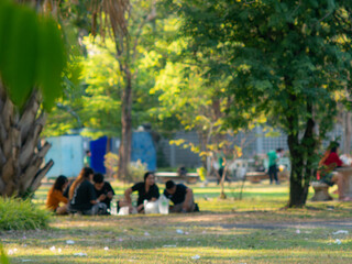 Blurred Background of People Sitting and Relaxing in Public Park