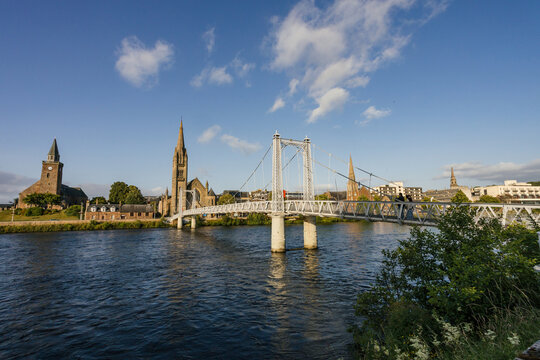 Historic Bridge Spans Calm River Against a Clear Sky at Sunset