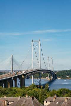 Bridge Spans River Under Clear Blue Sky on a Sunny Day