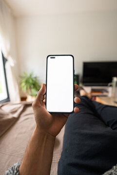 Person holding phone with blank screen while relaxing