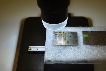 Closeup of a microscope lens and a tiny chip