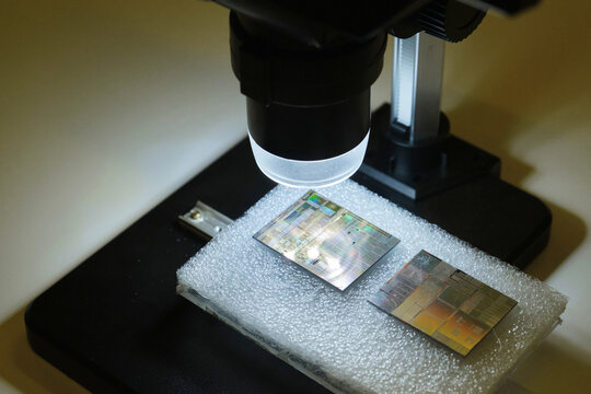 Closeup of a microscope lens and a tiny chip