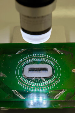 Closeup of a microscope lens and a tiny chip