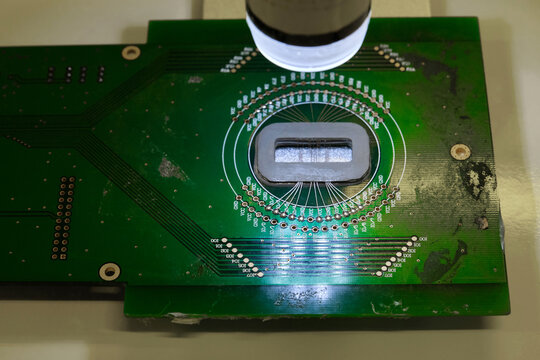 Closeup of a microscope lens and a tiny chip