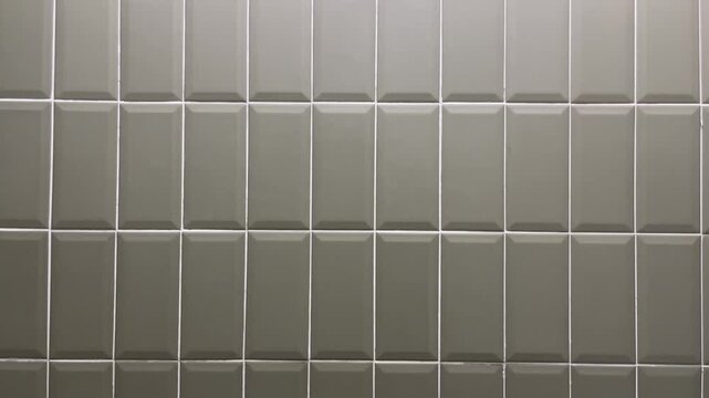 Side view of green tiles on the bathroom or restroom. wall. modern. copy space, empty, free, negative, text, design. background, backgrounds,  bright, light, lamp. front. close up.